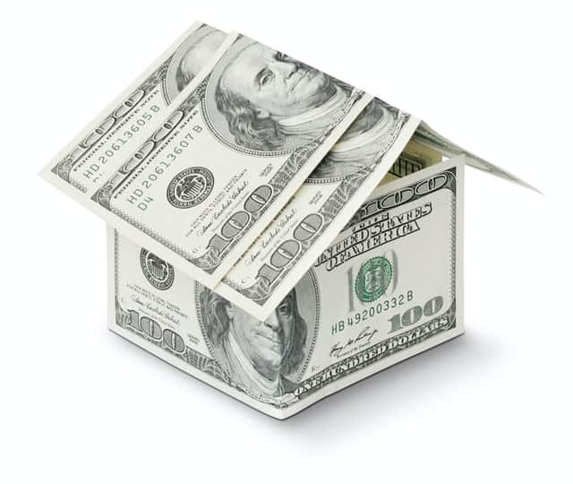 A house made of money representing home pricing mistakes sellers can make