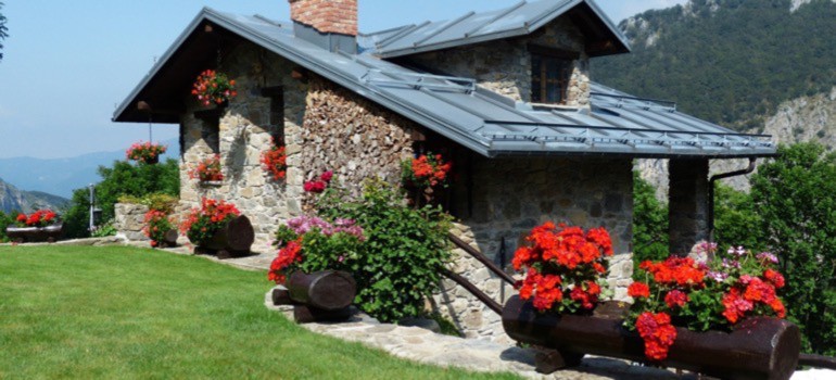 Old-fashioned stone brick house with floral decor 