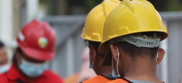 Construction workers in hard hats.